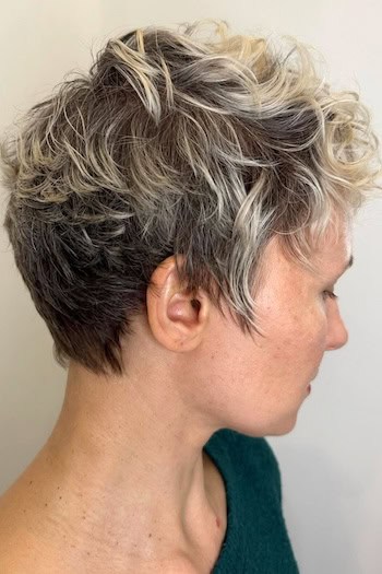 Messy Wavy Pixie with Highlights Haircut, side view.