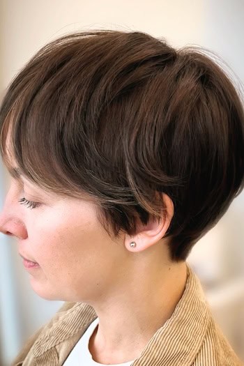 Brunette Pixie with Long Layers Haircut, side view.