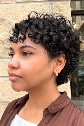 Curly Pixie with Bangs and Defined Ringlets Haircut, side view.
