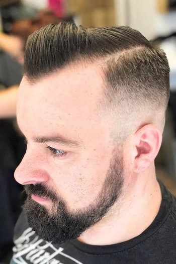 Side Parted Cut with Hard Line and Skin Fade Men's Haircut, side view.