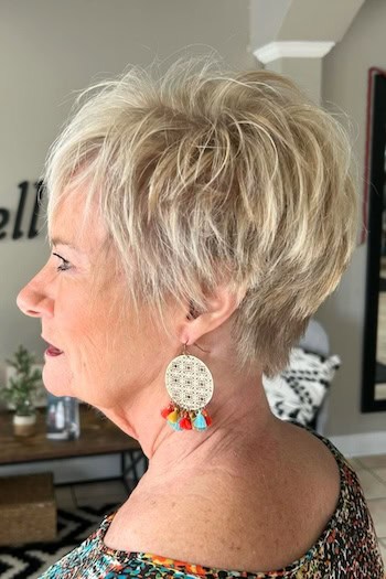 Long Layered Blonde Pixie With Light Texture Haircut, side view.