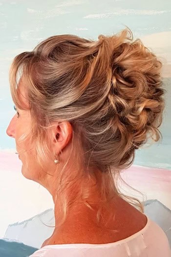 Twisted Updo Hairstyle on a woman in her 50s with thick hair, from back.