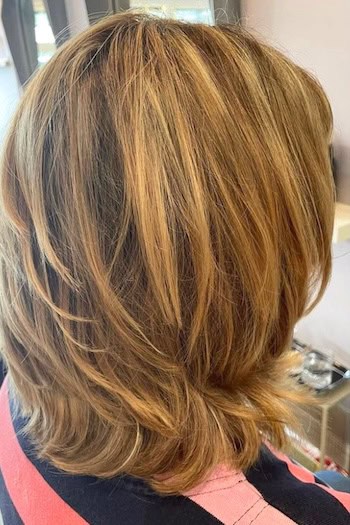 Layered Honey Blonde Midlength Cut Hairstyle, back view.