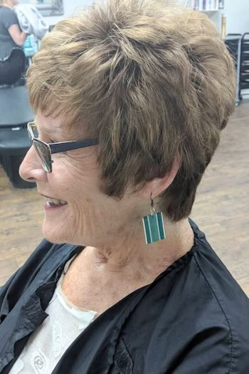 Layered Pixie With Crown Volume For Thick Hair Haircut, side view.