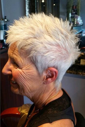 White Spiky Textured Pixie With Piecey Texture Haircut, side view.