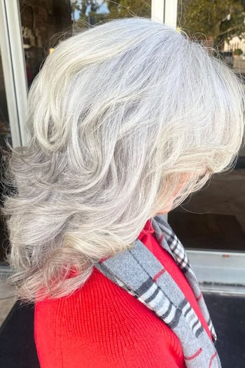 Voluminous Curled Silver Layers Hairstyle, side view.