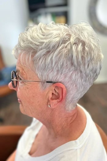 Piecey Silver Pixie With Tapered Nape Haircut, side view.