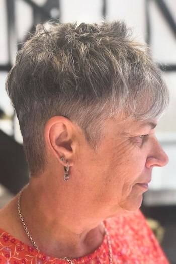 Silver Tapered Pixie With Shaved Sides And Textured Top Haircut, side view.