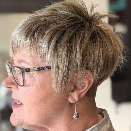 Choppy Pixie With Bangs And Textured Top Haircut, side view.