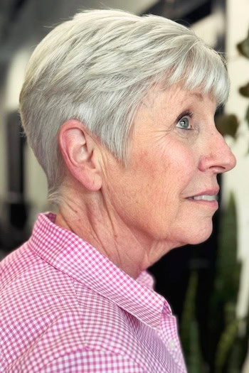 Soft Gray Tapered Pixie With Fringe Haircut, side view.