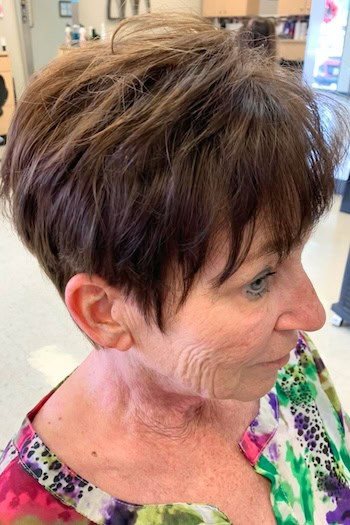 Textured Dark Brown Pixie With Piecey Bangs Haircut, side view.