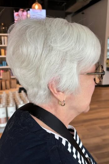 Pixie With Rounded Shape And Stacked Back Haircut, side view.