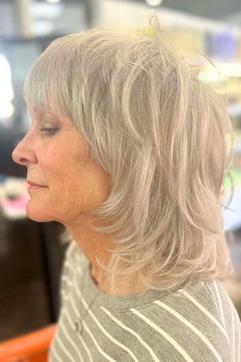 Layered Medium Shag With Flipped Ends And Full Bangs Hairstyle