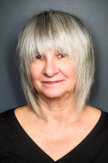 Silver Shag With Angled Layers And Full Fringe Hairstyle
