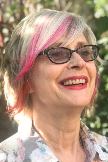 Short Shaggy Bob With Pink Streaks And Side-Swept Bangs Hairstyle