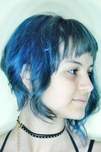 Blue Asymmetrical Bob with Baby Bangs Hairstyle, side view.