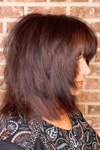 Straight Brunette Shaggy Layers Haircut, side view.