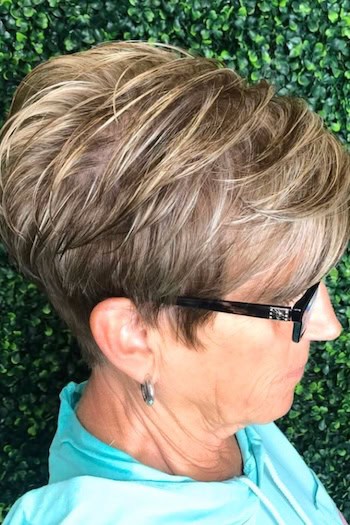 Layered Pixie with Bangs and Textured Crown Hairstyle, side view.