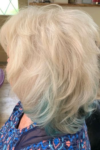 Textured Medium Layers With Blue Peek-A-Boo Highlights Hairstyle