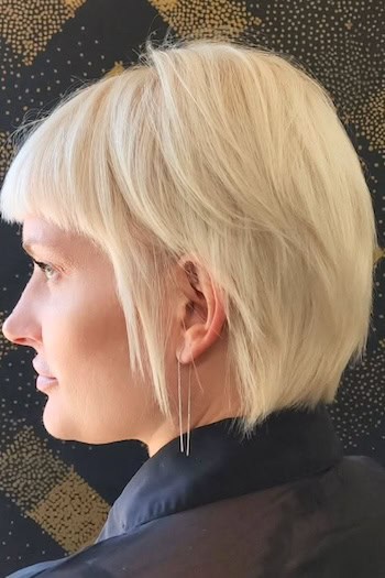 Platinum Layers with Textured Bangs Hairstyle, side view.