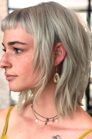 Silver Platinum Textured Shag with Micro Bangs Haircut, side view.