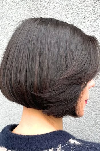 Brunette Precision Bob With Face-Framing Layers Hairstyle, side view.