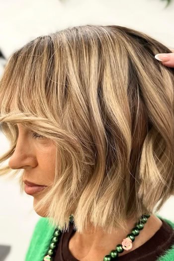 Chunky Textured Bob With Bangs Hairstyle, side view.