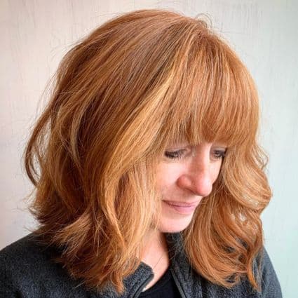 Medium-Length Shaggy Lob With Layers And Thick Bangs Haircut