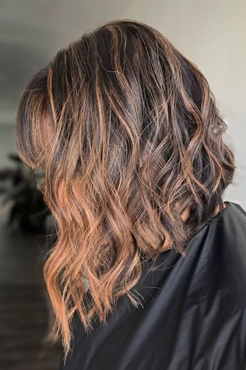 Highlighted Wavy Angled Lob Hairstyle, side view.