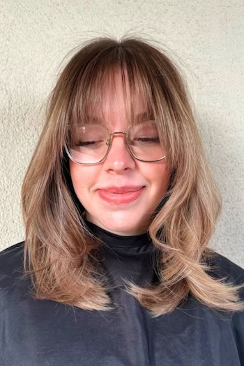 Tousled Medium Layers With See-Through Bangs Haircut