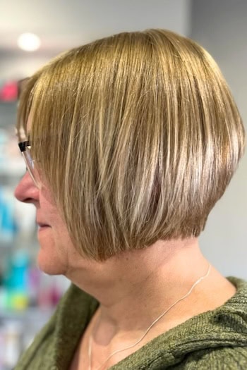 Short Bob With Subtle Layers Hairstyle on a woman in her 60s wearing glasses, side view.
