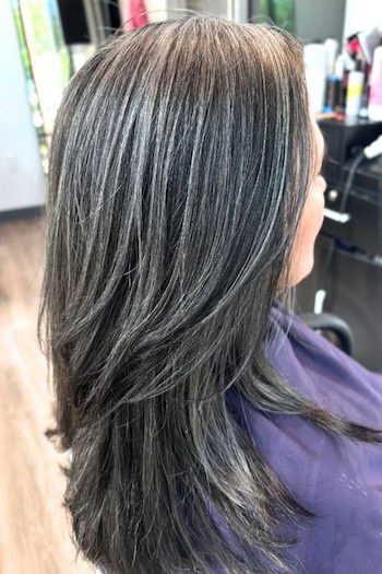 Natural Gray Streaked Layers on Dark Hair, side view.