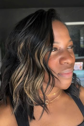 Side-Swept Waves With Face-Framing Highlights Haircut