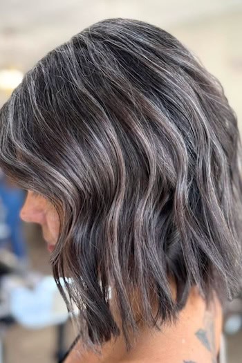 Choppy Gray Blunt Waves on Dark Hair, side view.