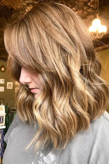 Thick Wavy Light Brown Lob With Bangs Haircut