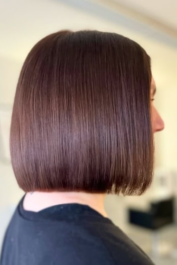 Sleek Chocolate Brown Blunt Bob Hairstyle, side view.