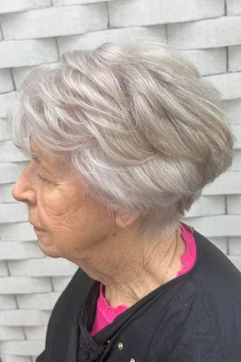 Voluminous Short Layered Silver Bob with Bangs Haircut, side view.