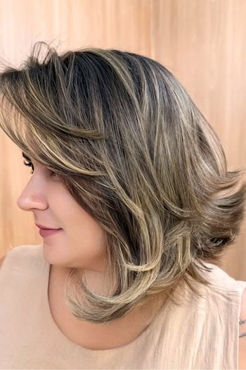 Brunette Disconnected Layered Lob Hairstyle, side view.