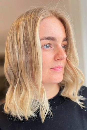 Blonde Long Bob with Subtle Waves Hairstyle, side view.