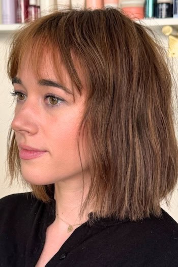 Wispy Long Bob with Bangs Hairstyle, side view.