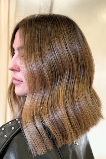 Warm Brown Sleek Angled Lob Hairstyle, side view.