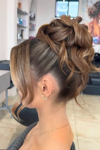 Elegant High Updo With Loose Strands Hairstyle