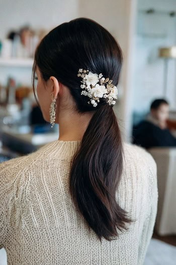 Low Ponytail with Floral Accessory Hairstyle