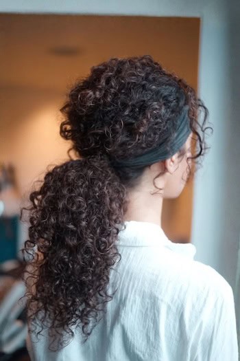 Low Curly Ponytail with Headband Hairstyle