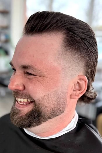 Slicked Back Fade with Tapered Sides Haircut